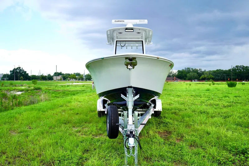 Slide: The Image of 2019 Sportsman Open 282 Center Console boat on trailer in grassy field. - 2