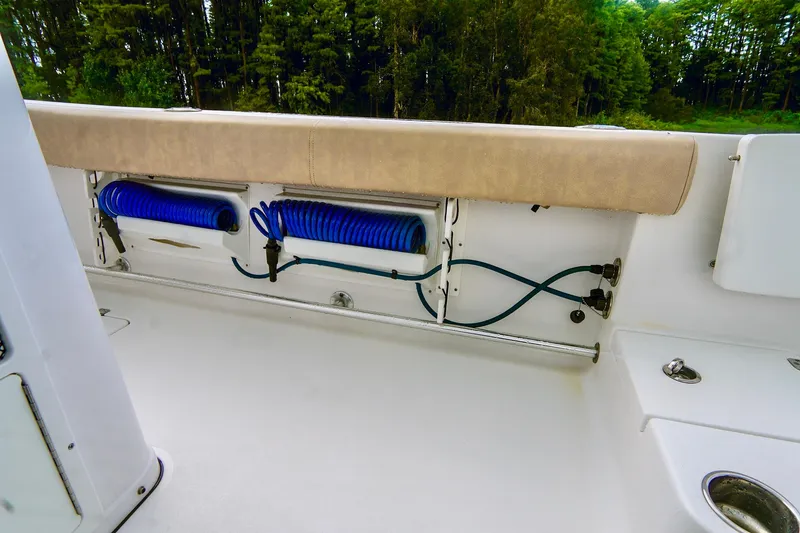 Slide: The Image of 2019 Sportsman Open 282 Center Console boat interior with coiled blue hoses. - 22