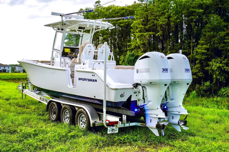 Slide: The Image of 2019 Sportsman Open 282 Center Console boat on a trailer in a grassy area. - 26