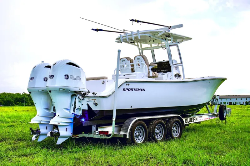 Slide: The Image of 2019 Sportsman Open 282 Center Console boat on a trailer in a grassy field. - 27