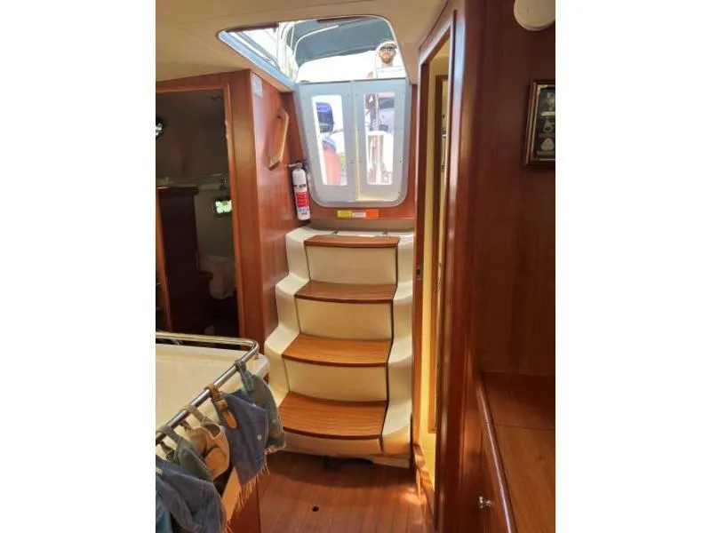 Slide: The Image of Interior of 2012 Hunter 36E sailboat with wooden steps and cabin view. - 5