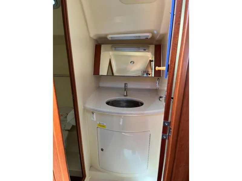 Slide: The Image of 2012 Hunter 36E yacht bathroom with sink, mirror, and storage cabinet. - 7