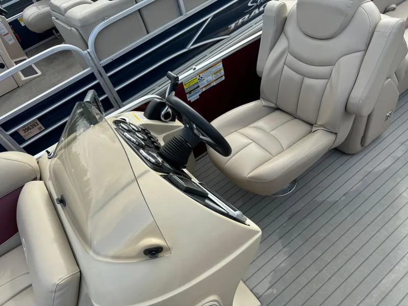 Slide: The Image of Captain's seat and helm of a 2016 Godfrey Sweet Water pontoon boat. - 12