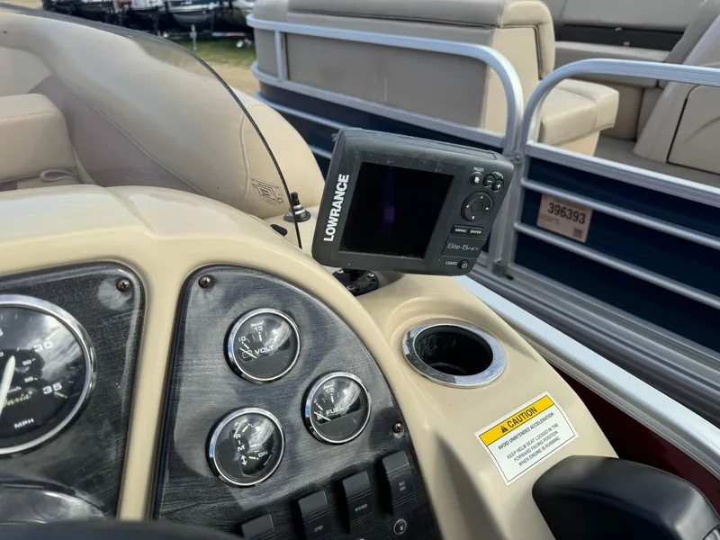 Slide: The Image of Dashboard of a 2016 Godfrey Sweet Water boat with gauges and a Lowrance device. - 18