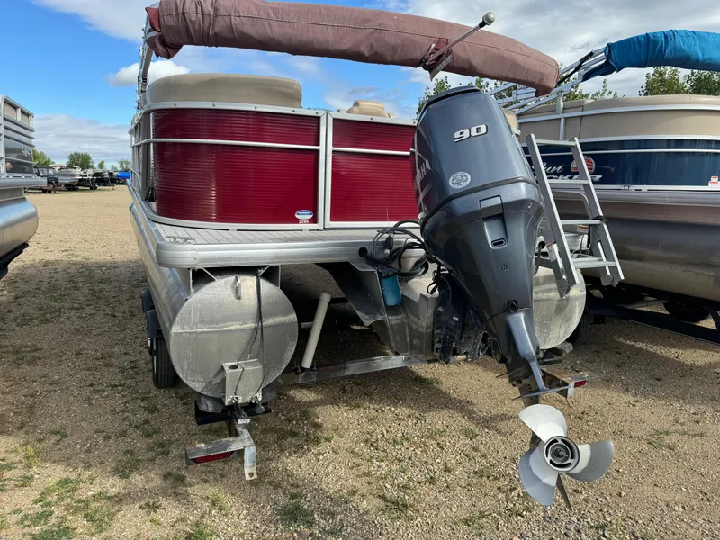 Slide: The Image of 2016 Godfrey Sweet Water pontoon boat with 90 HP motor, parked on gravel. - 6