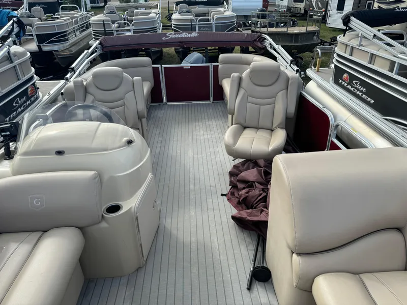 Slide: The Image of 2016 Godfrey Sweet Water pontoon boat with beige seating and spacious deck layout. - 7
