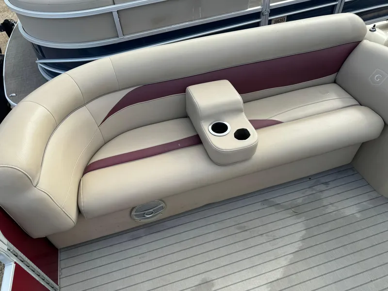 Slide: The Image of 2016 Godfrey Sweet Water boat seat with beige and maroon upholstery, featuring a cup holder. - 9