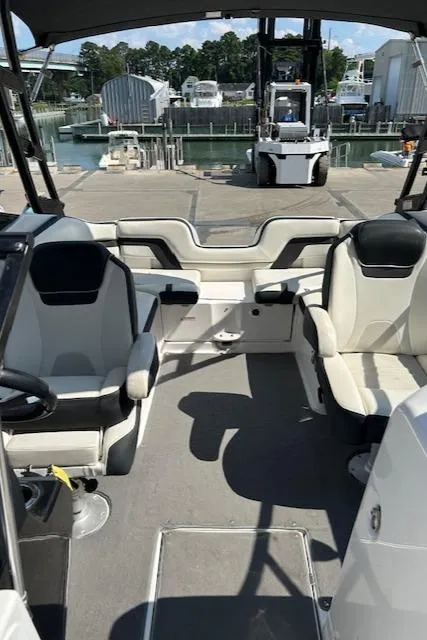 Slide: The Image of 2016 Yamaha Boats AR240 interior with seating, docked at marina. - 10