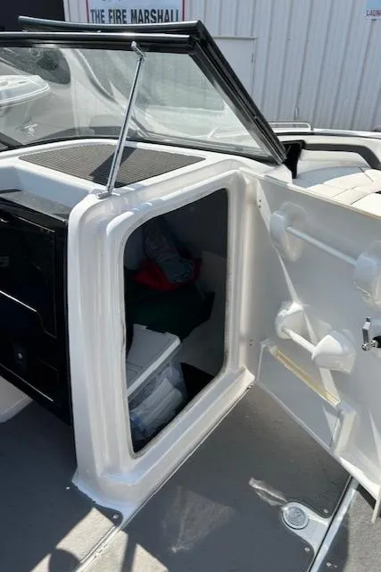 Slide: The Image of 2016 Yamaha Boats AR240 storage compartment with open door. - 11