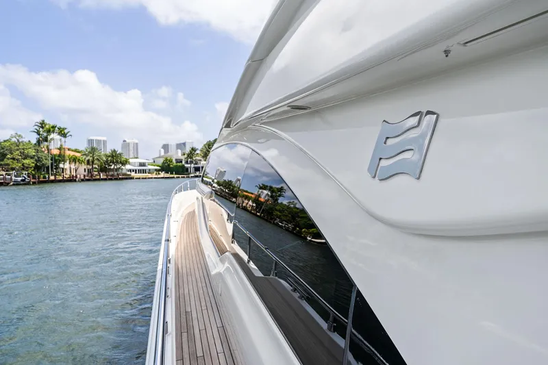 Slide: The Image of 2015 Ferretti Yachts 690 cruising on a scenic waterway, showcasing sleek design and luxury. - 23