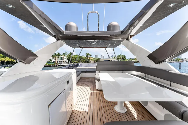 Slide: The Image of Luxurious 2015 Ferretti Yachts 690 flybridge with sleek seating and dining area. - 26