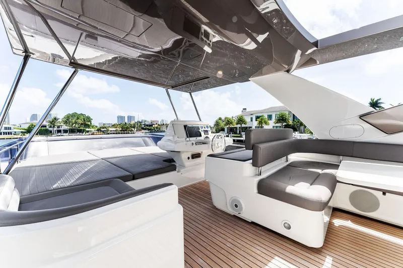 Slide: The Image of Luxurious 2015 Ferretti Yachts 690 flybridge with modern seating and helm, docked in a marina. - 37