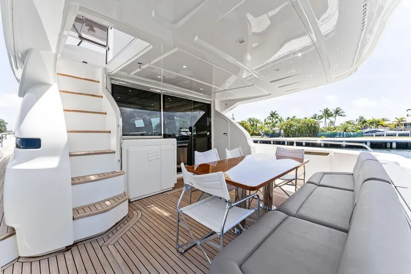 Slide: The Image of Luxurious 2015 Ferretti Yachts 690 deck with seating, table, and staircase. - 38