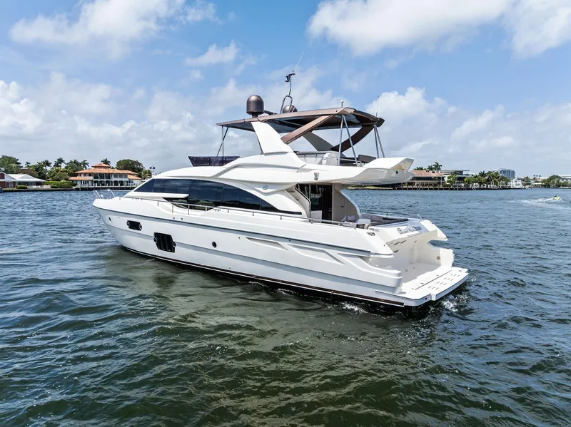 Slide: The Image of 2015 Ferretti Yachts 690 cruising on a sunny day, showcasing sleek design and luxury. - 6
