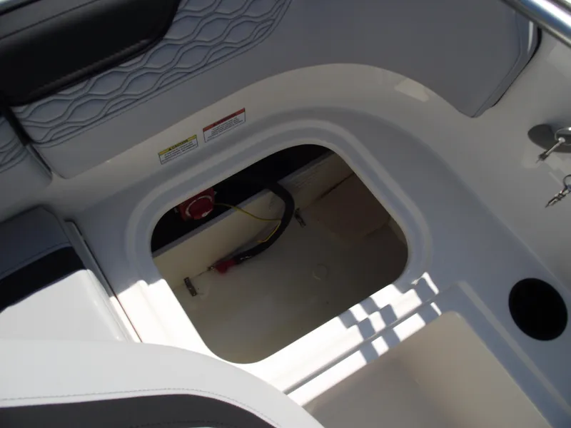 Slide: The Image of 2024 Bayliner Element M17 boat storage compartment with wiring and battery switch. - 13