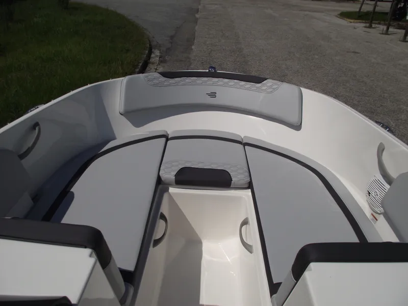 Slide: The Image of 2024 Bayliner Element M17 boat interior with cushioned seating and storage compartments. - 20