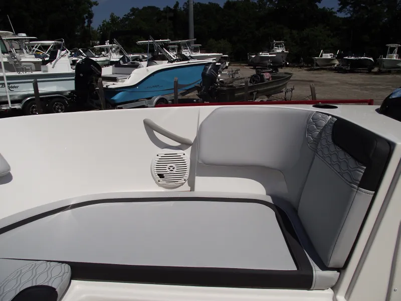 Slide: The Image of 2024 Bayliner Element M17 boat interior with cushioned seating and speaker. - 23