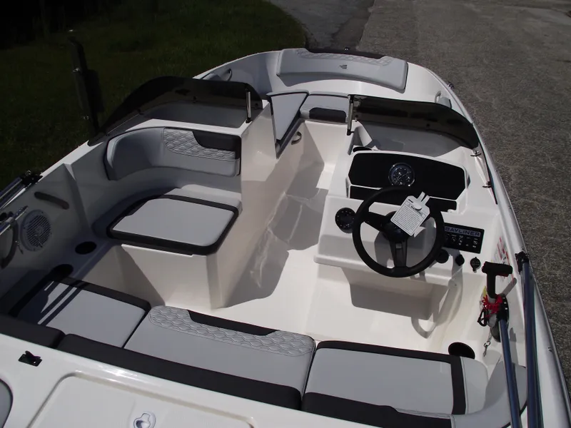 Slide: The Image of 2024 Bayliner Element M17 boat interior with seating and steering console. - 9