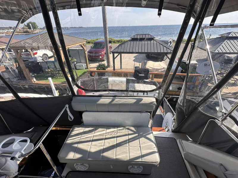 Slide: The Image of 1987 Silverton 40 Double Cabin boat interior with ocean view and seating area. - 18