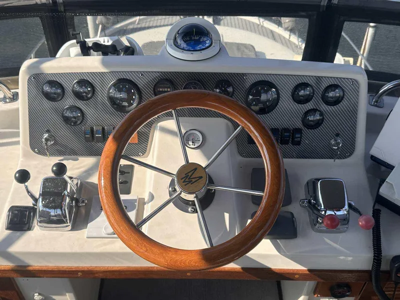 Slide: The Image of 1987 Silverton 40 Double Cabin helm with wooden steering wheel and instrument panel. - 21