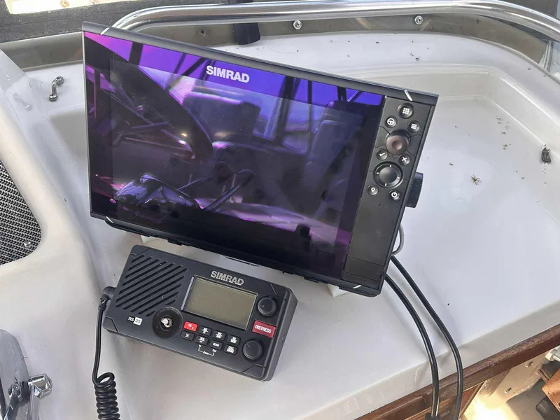 Slide: The Image of Simrad marine electronics on 1987 Silverton 40 Double Cabin boat dashboard. - 22