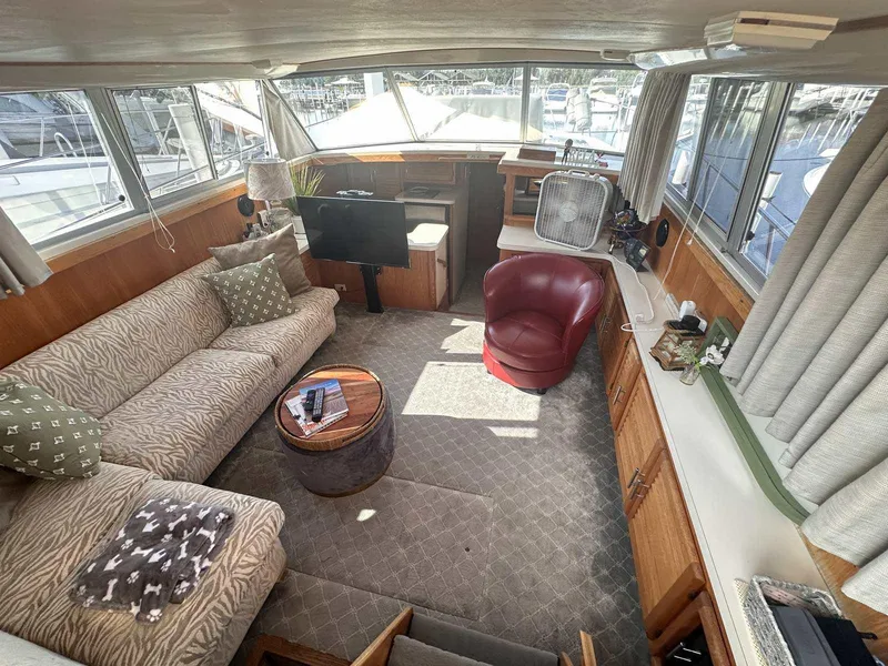 Slide: The Image of 1987 Silverton 40 Double Cabin interior with cozy seating and nautical decor. - 24