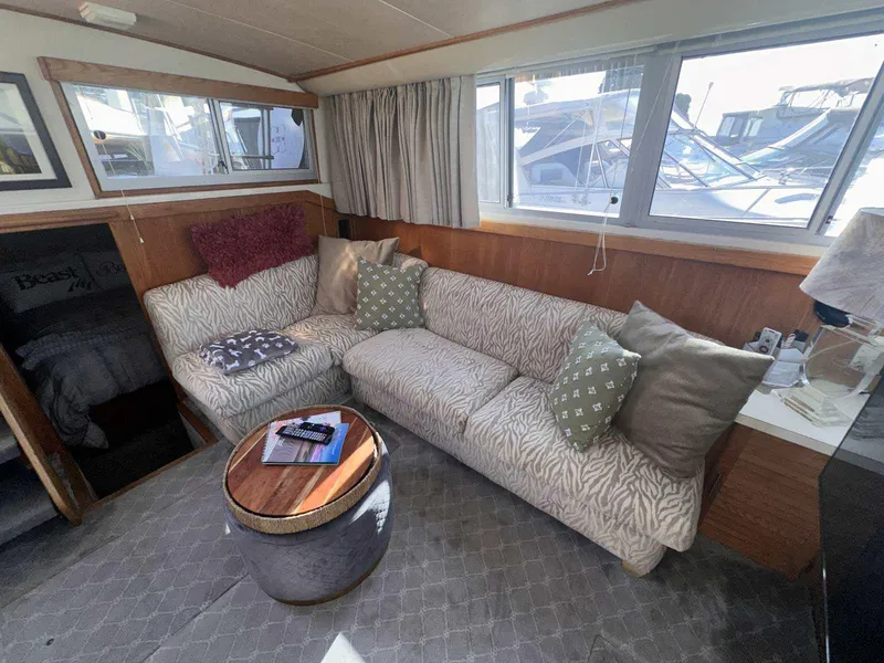 Slide: The Image of 1987 Silverton 40 Double Cabin interior with cozy seating and nautical decor. - 25