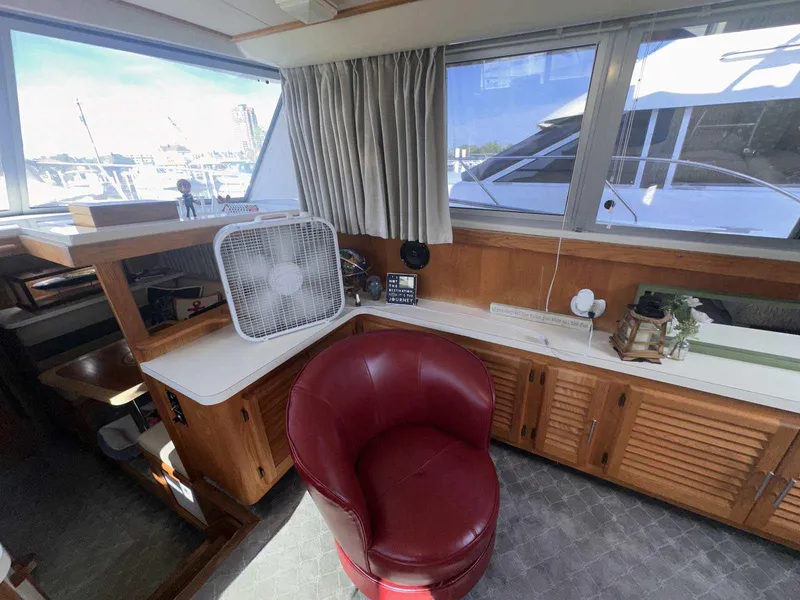Slide: The Image of Interior of 1987 Silverton 40 Double Cabin with red chair and fan. - 27
