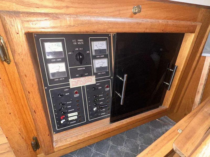 Slide: The Image of Electrical panel of a 1987 Silverton 40 Double Cabin boat, featuring gauges and switches. - 29