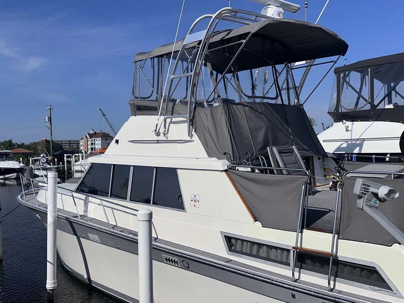 Slide: The Image of 1987 Silverton 40 Double Cabin yacht docked at marina under clear blue sky. - 3