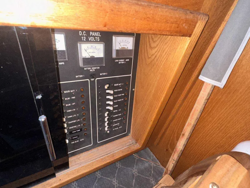 Slide: The Image of 1987 Silverton 40 Double Cabin DC panel with switches and gauges. - 30