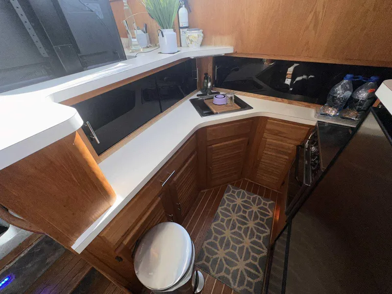 Slide: The Image of 1987 Silverton 40 Double Cabin kitchen with wooden cabinets, countertop, and stove. - 31
