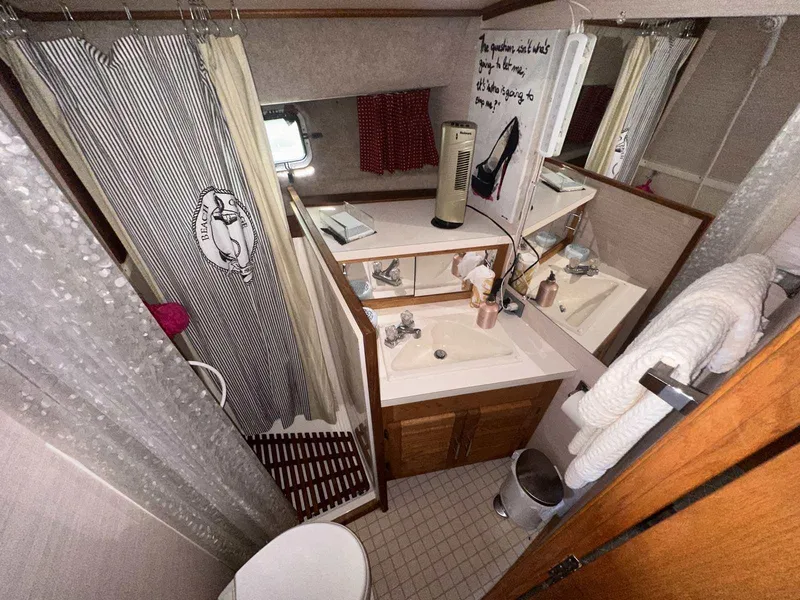 Slide: The Image of 1987 Silverton 40 Double Cabin bathroom with shower, sink, and mirror. - 33