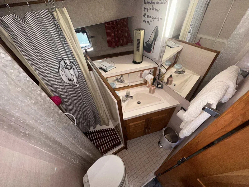 Slide: The Image of 1987 Silverton 40 Double Cabin bathroom with shower, sink, and mirror. - 35