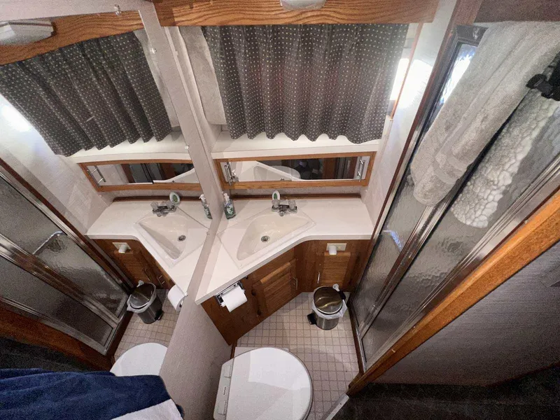 Slide: The Image of 1987 Silverton 40 Double Cabin bathroom with dual sinks, mirrors, and shower. - 43