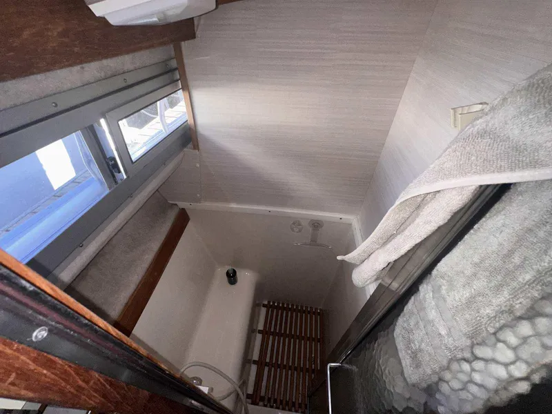 Slide: The Image of 1987 Silverton 40 Double Cabin bathroom with shower, window, and towel rack. - 44