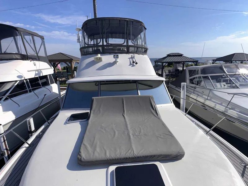 Slide: The Image of 1987 Silverton 40 Double Cabin yacht with sun pad, docked alongside similar boats. - 6