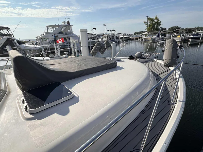 Slide: The Image of 1987 Silverton 40 Double Cabin yacht docked at marina with Canadian flag. - 7