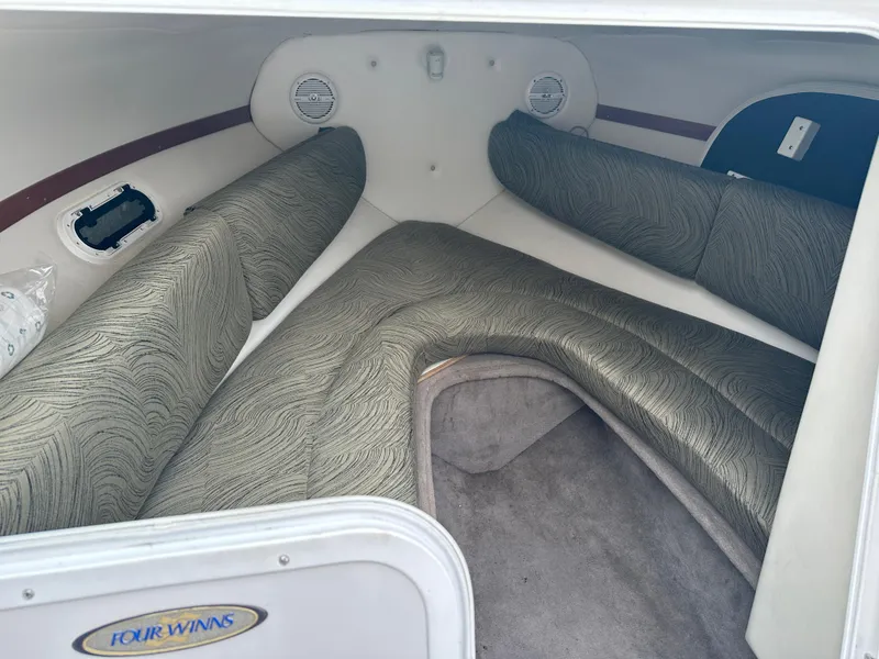 Slide: The Image of Interior cabin of a 2003 Four Winns 205 Sundowner boat with cushioned seating. - 13