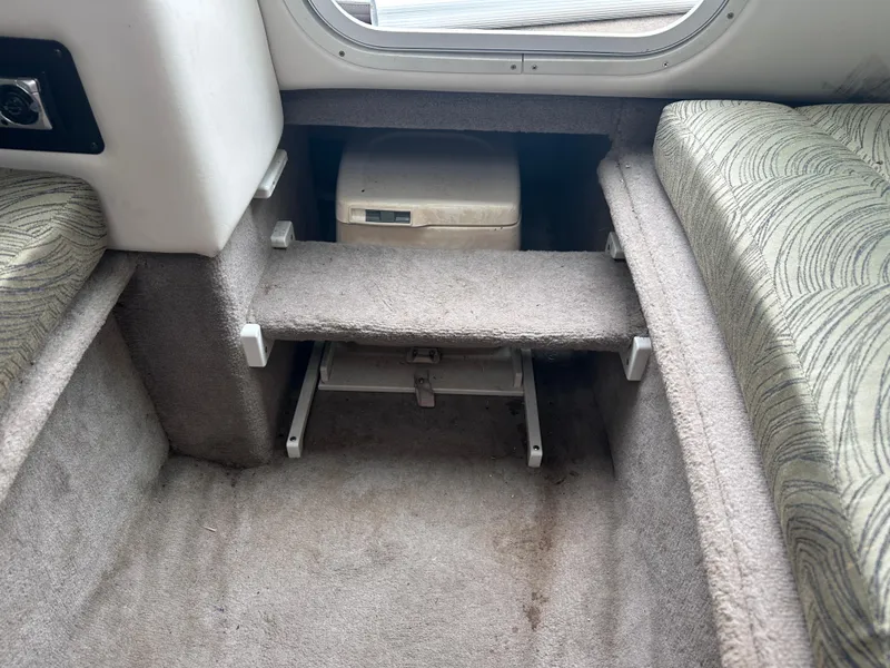 Slide: The Image of Interior cabin of a 2003 Four Winns 205 Sundowner boat with carpeted flooring. - 14