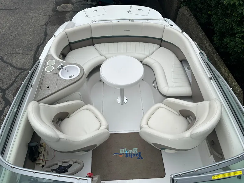 Slide: The Image of 2003 Four Winns 205 Sundowner boat interior with white seating and round table. - 16