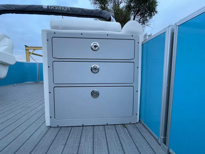 Slide: The Image of 2024 Godfrey Sweetwater 2086 BF boat storage drawers on deck. - 13