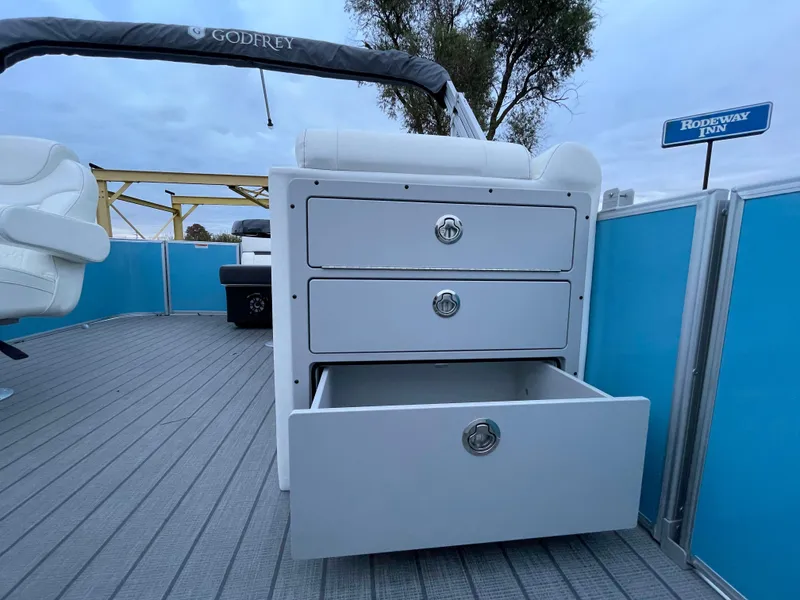 Slide: The Image of 2024 Godfrey Sweetwater 2086 BF boat interior with storage drawers. - 14