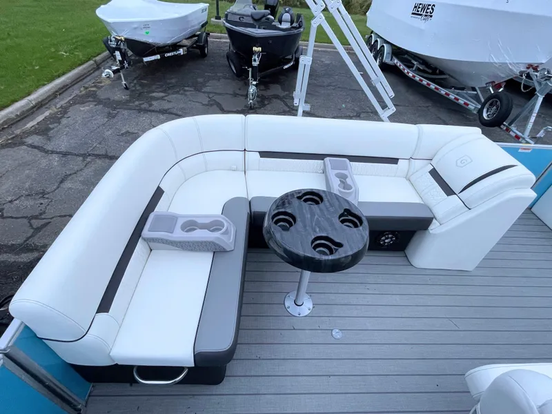 Slide: The Image of 2024 Godfrey Sweetwater 2086 BF boat interior with white seating and round table. - 15