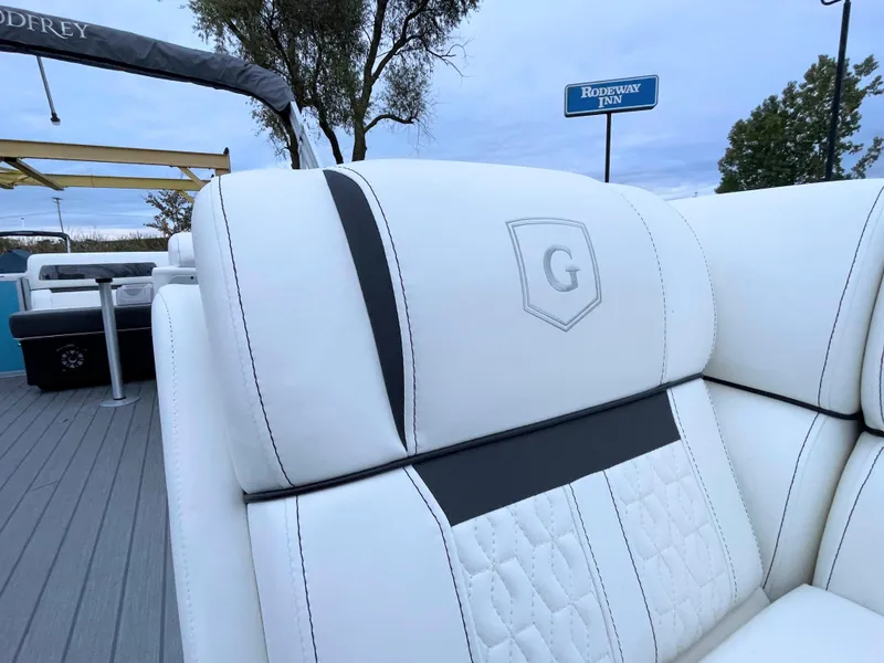Slide: The Image of 2024 Godfrey Sweetwater 2086 BF boat with luxurious white seating. - 18