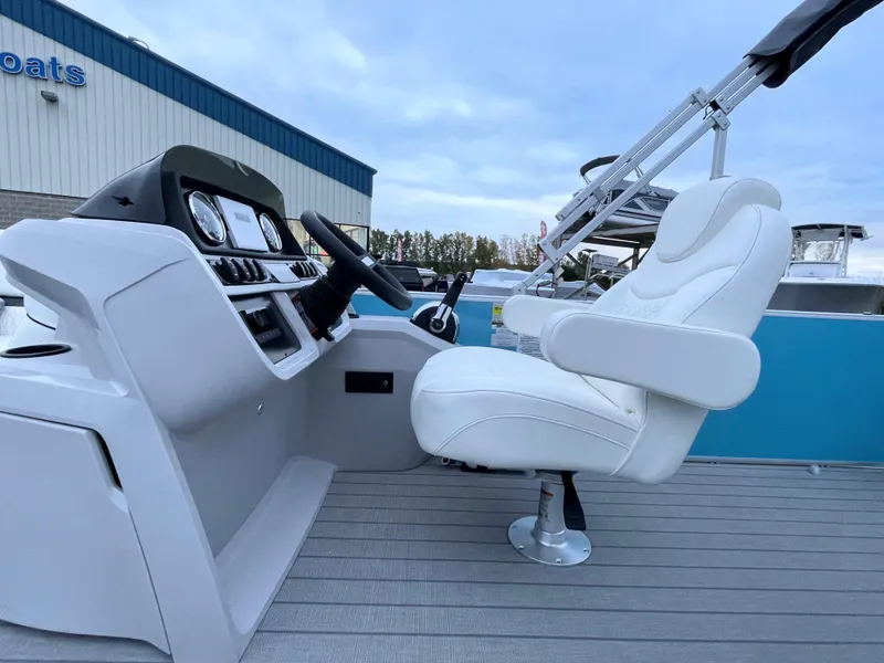 Slide: The Image of 2024 Godfrey Sweetwater 2086 BF boat interior with captain's chair and control console. - 7