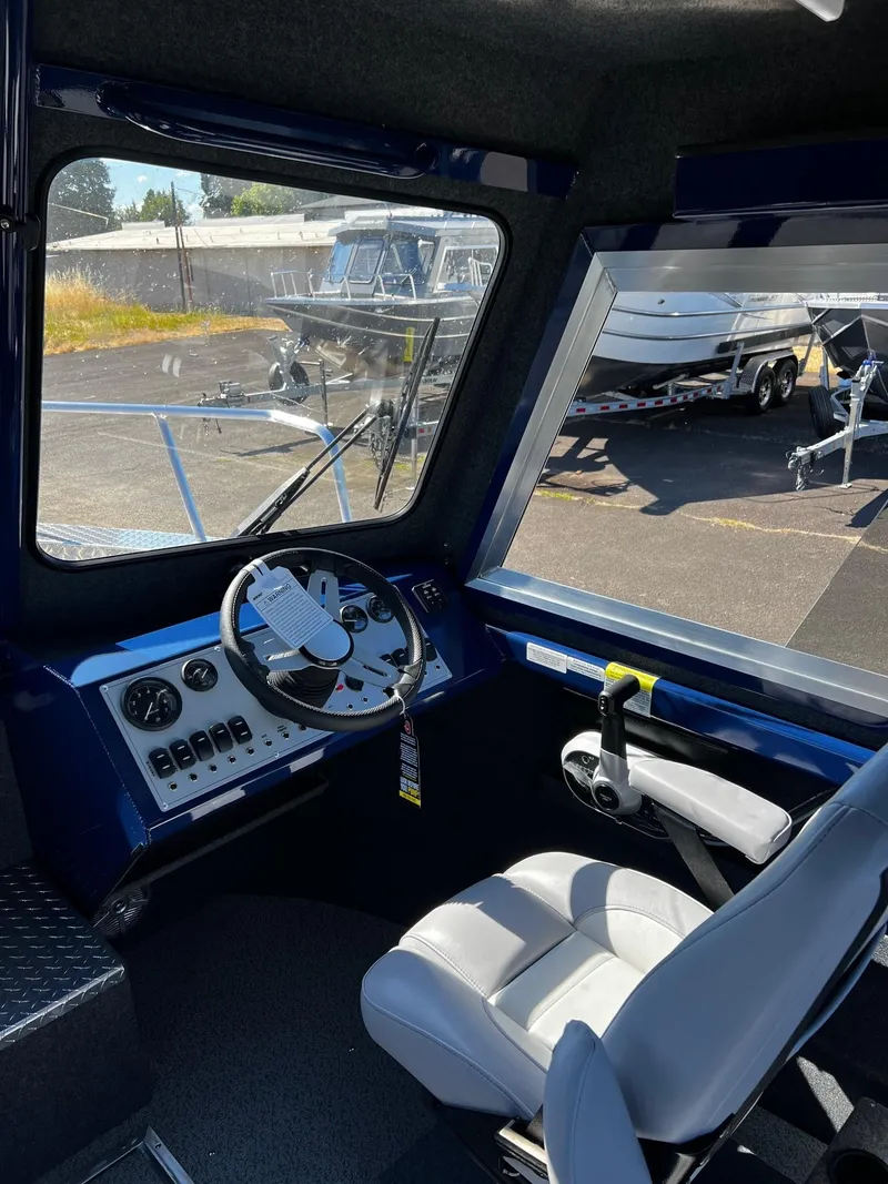 Slide: The Image of 2024 Thunder Jet 22 Alexis Pro boat interior with steering wheel and controls. - 11