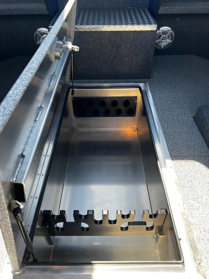 Slide: The Image of 2024 Thunder Jet 22 Alexis Pro boat storage compartment with rod holders. - 16