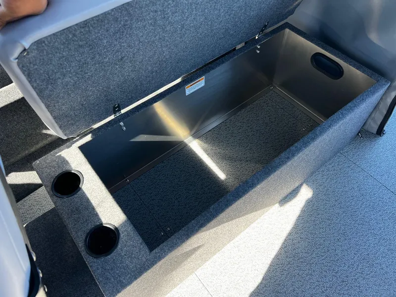 Slide: The Image of 2024 Thunder Jet 22 Alexis Pro storage compartment with cup holders. - 17