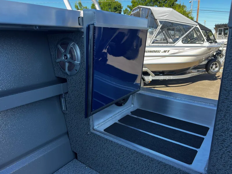 Slide: The Image of Interior view of 2024 Thunder Jet 22 Alexis Pro boat with exterior in background. - 26